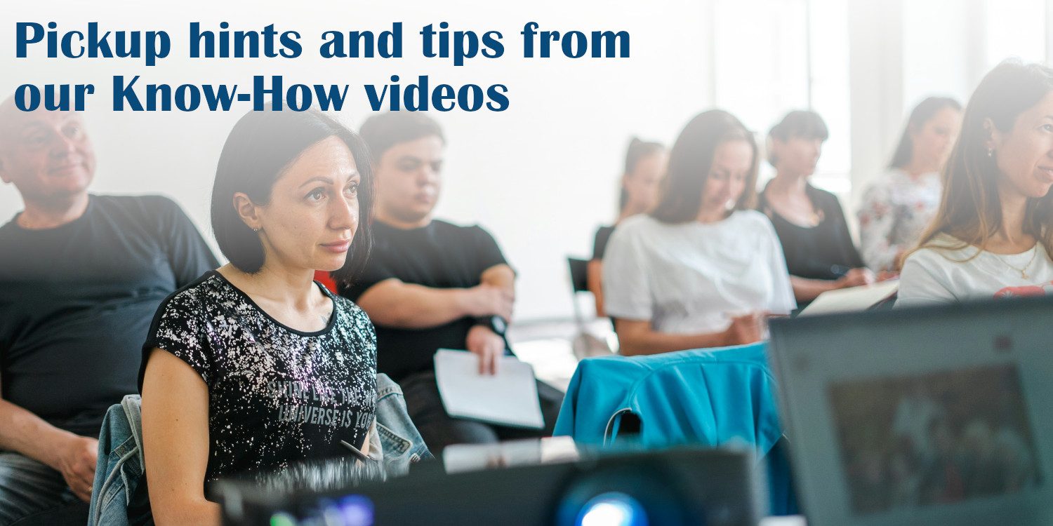 Tutorial Videos The image shows a class of mature students looking forward with some of them taking notes. There is a caption superimposed.